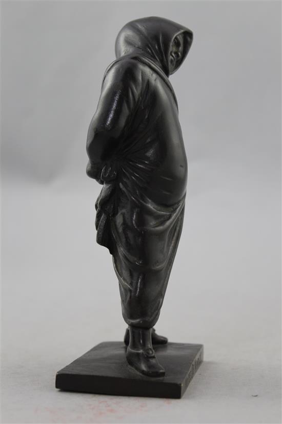 A small Italian patinated bronze of a figure standing in a hooded cloak, 6.75in.